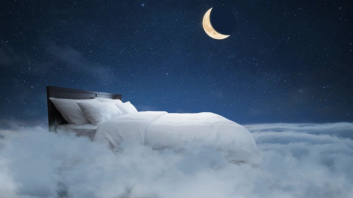A comfortable white bed on a cloud in the sky, with a moon shining above